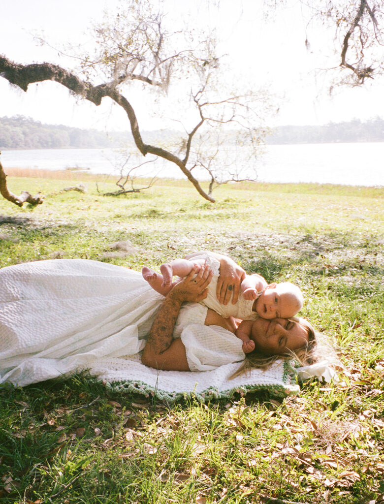 mom and baby smiling on a picnic blanket in Tallahassee