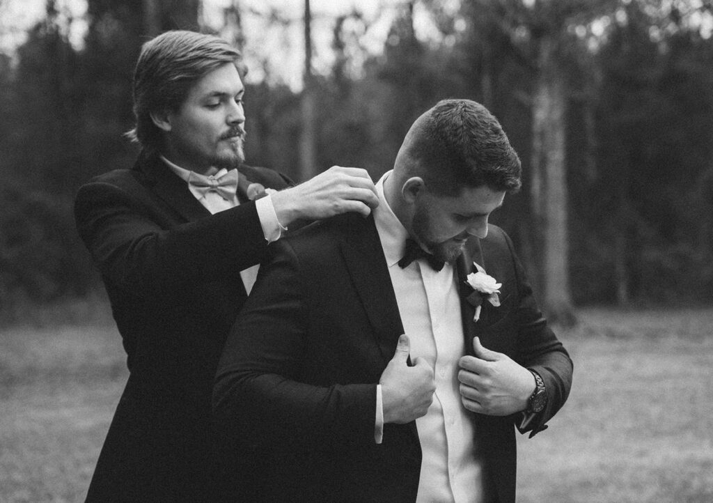 groomsman helping groom get ready