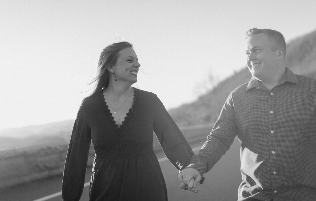 couple running during sunset while holding hands