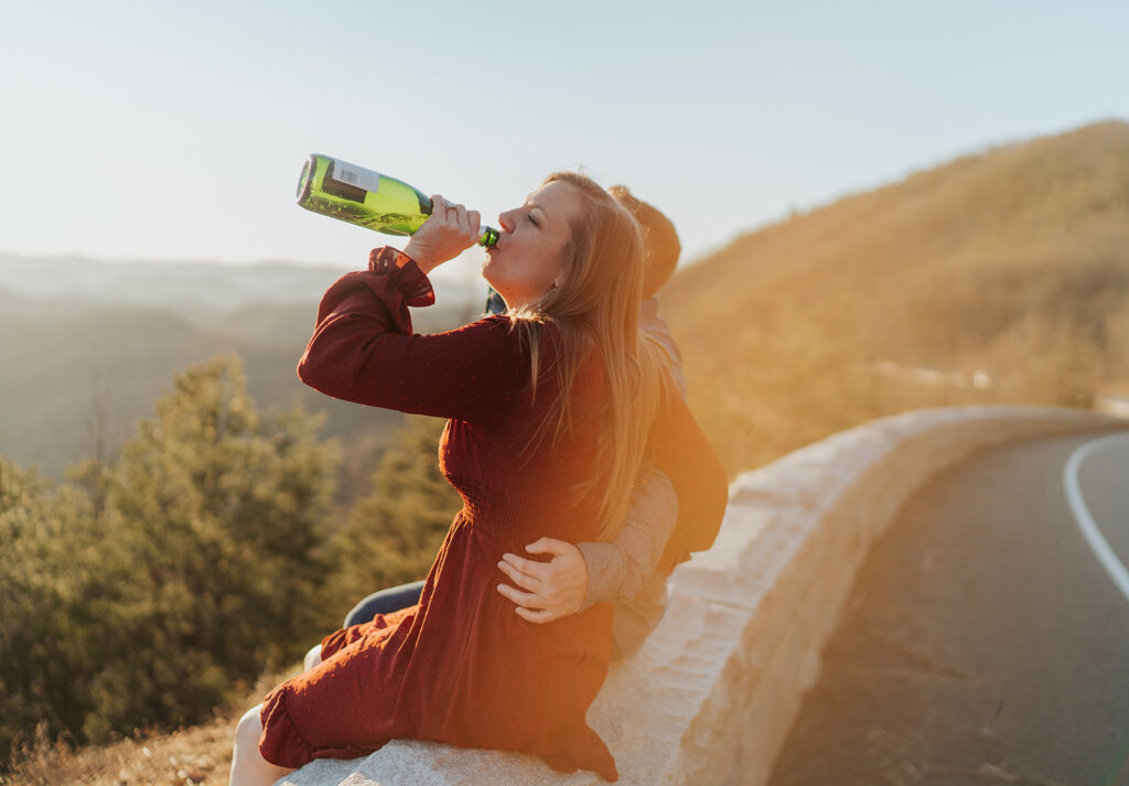 popping the Champagne engagement photos in the mountains
