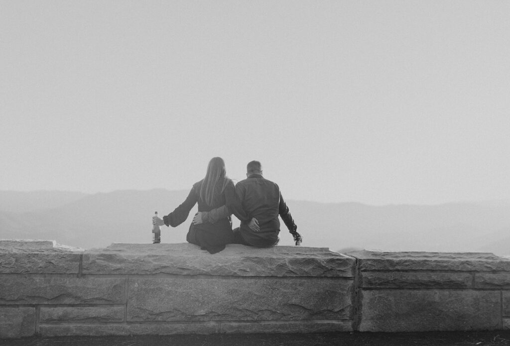 couple watching the sunset to celebrate engagement