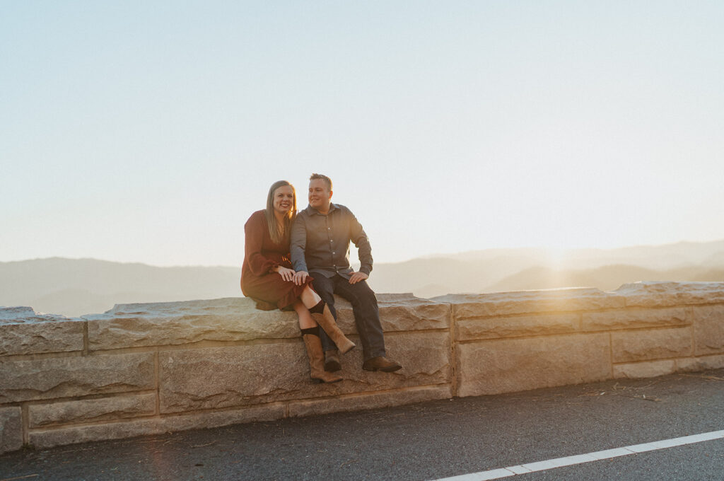 couple watching the sunset to celebrate engagement