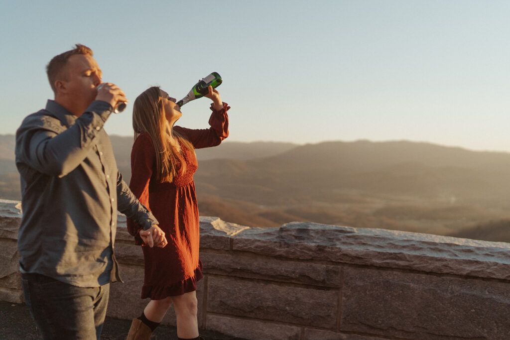 couple watching the sunset to celebrate engagement