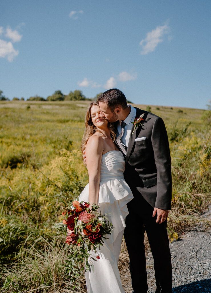 bride and groom smiling for wedding portraits during golden hour