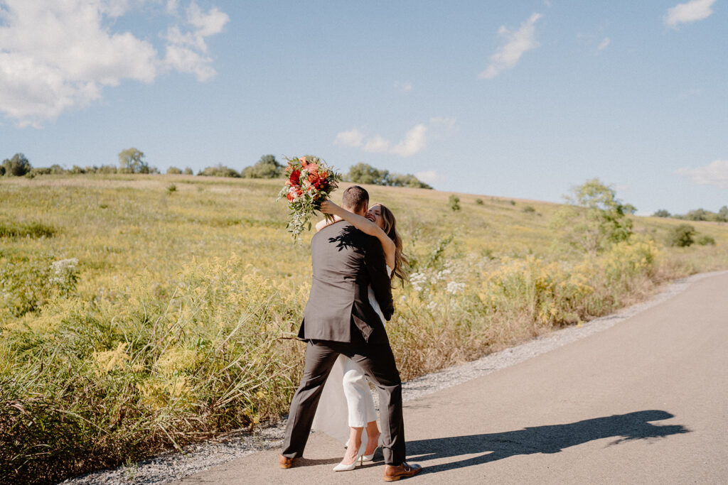 bride and groom smiling for wedding portraits during golden hour