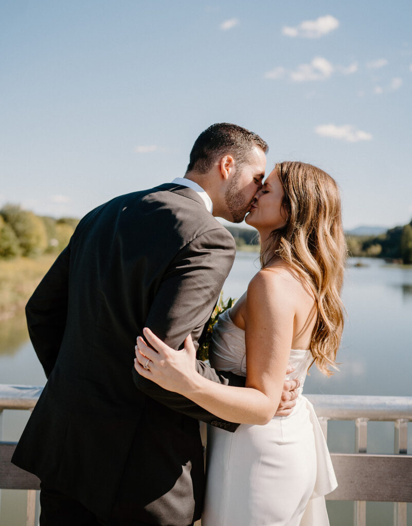 bride and groom kissing for wedding portraits during golden hour