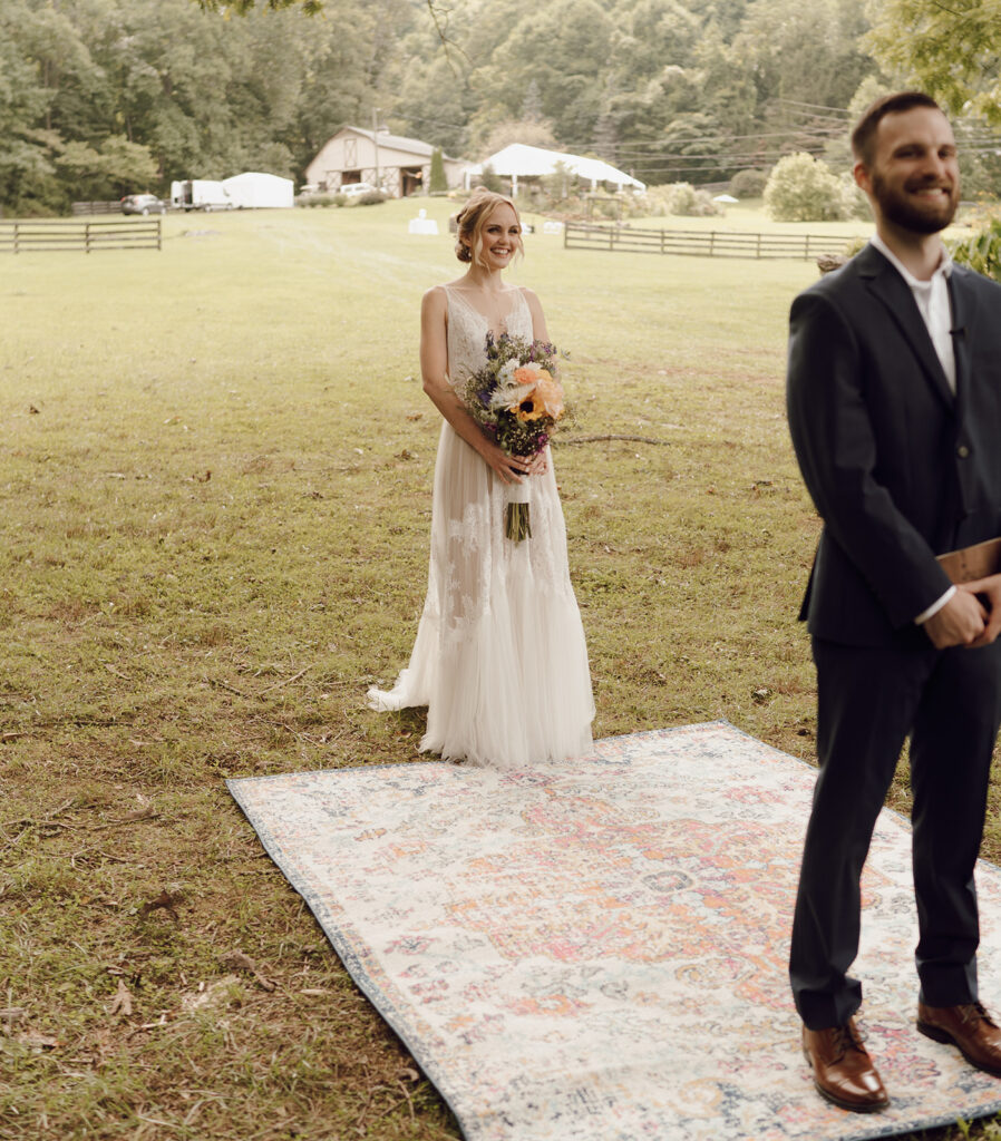 first look with bride and groom on vintage rug outdoors