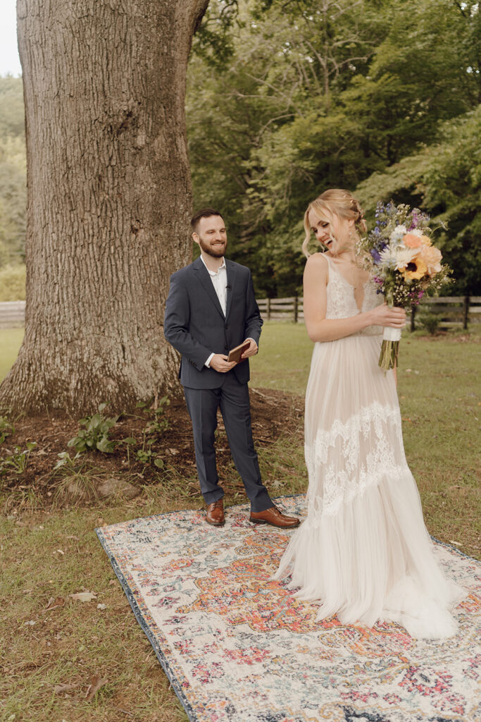 first look with bride and groom on vintage rug outdoors
