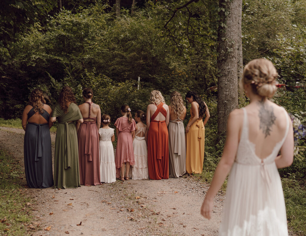 first look with bridesmaids fall rustic colors