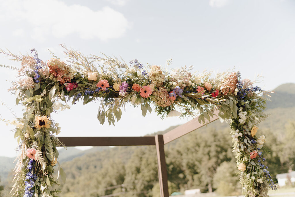fall rustic wedding floral arch at altar