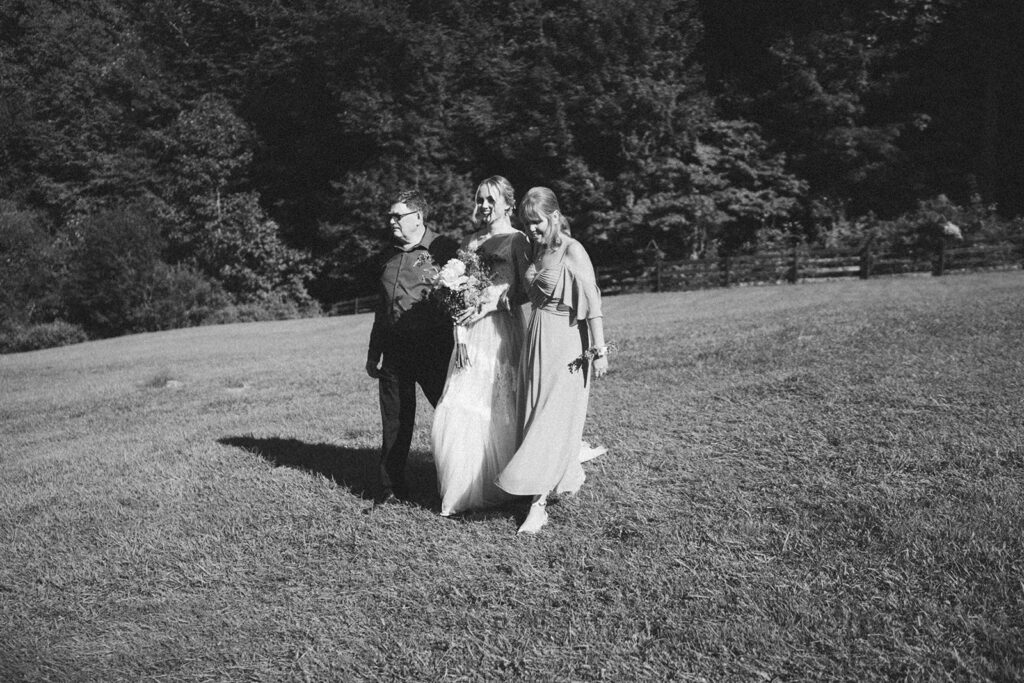 bride walking down the aisle at outdoor wedding venue
