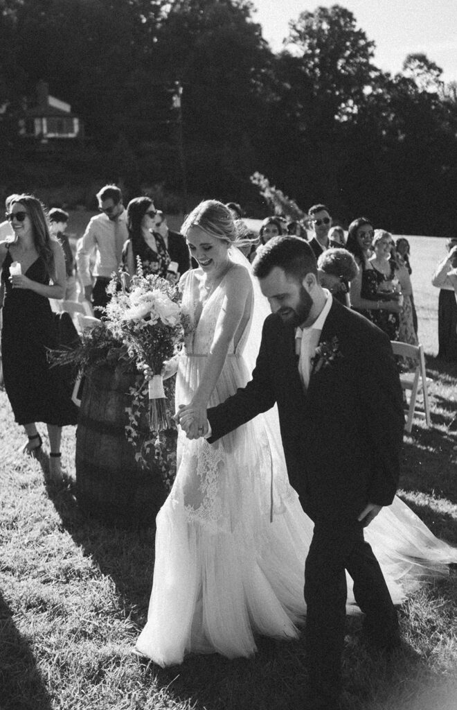 bride and groom walking back down the aisle after ceremony at the fields of blackberry cove