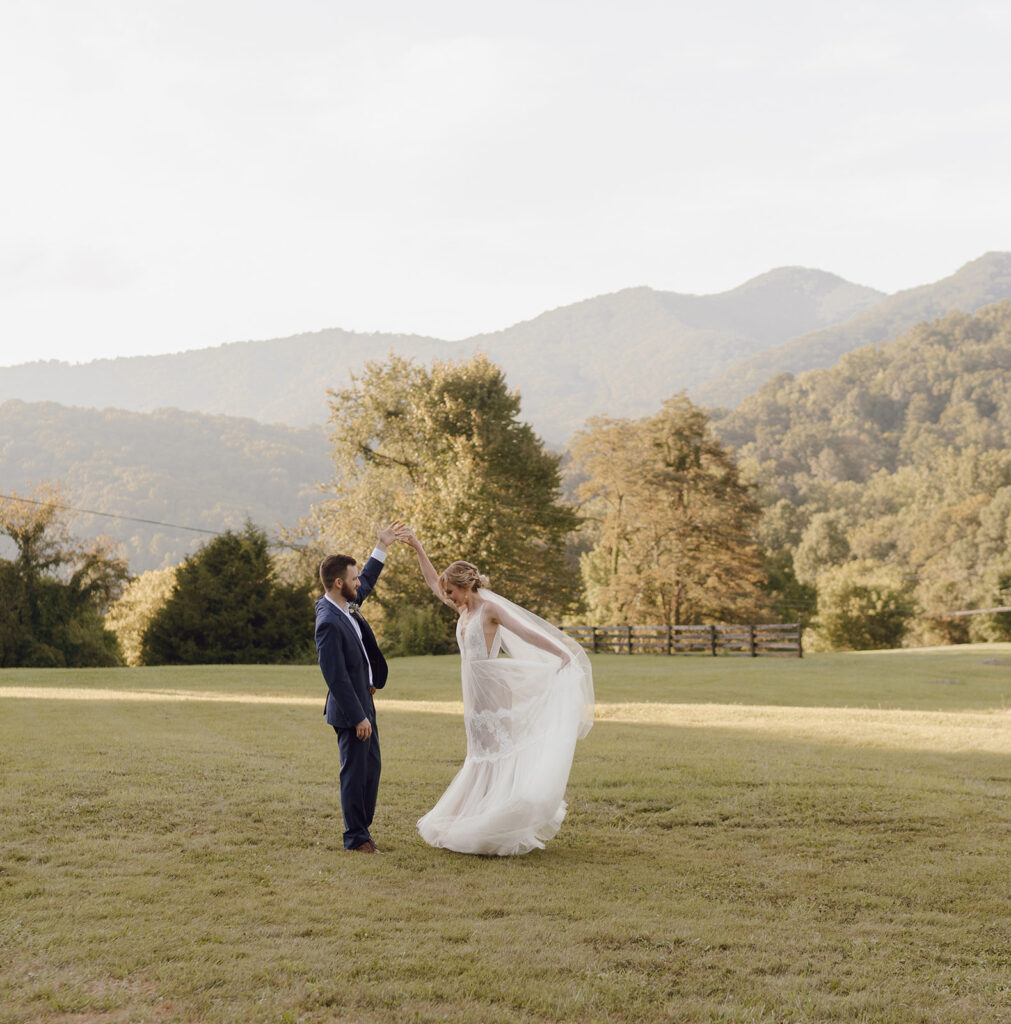 romantic bride and groom wedding photos in front of the mountains at the fields of blackberry cove