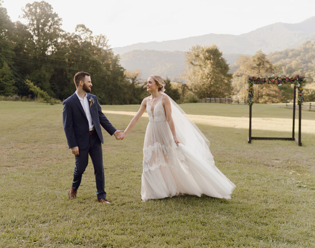 romantic bride and groom wedding photos in front of the mountains at the fields of blackberry cove