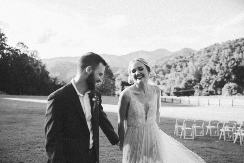 romantic bride and groom wedding photos in front of the mountains at the fields of blackberry cove