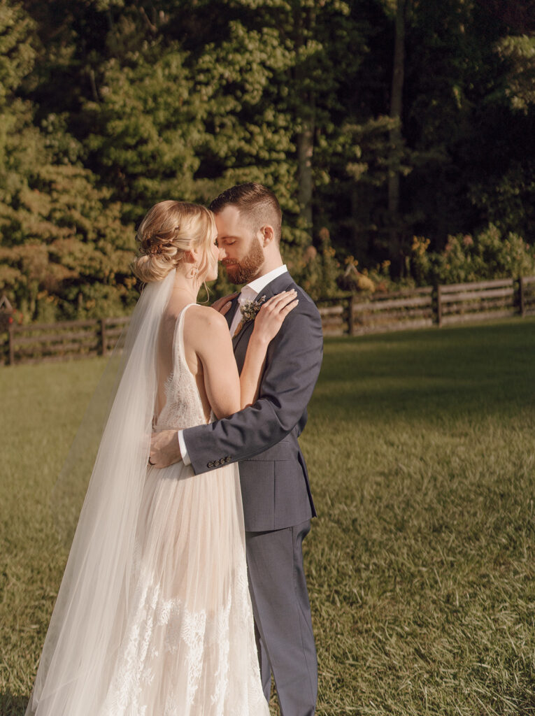 golden hour wedding portraits with bride and groom at the fields of blackberry cove