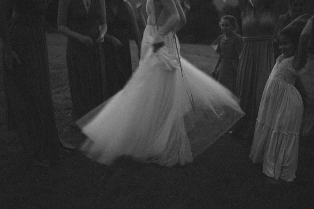 bride spinning and twirling around with her bridesmaids