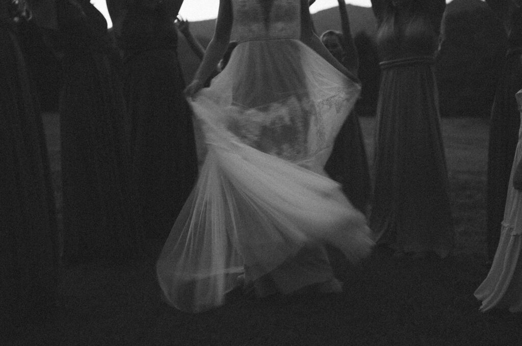 bride spinning and twirling around with her bridesmaids