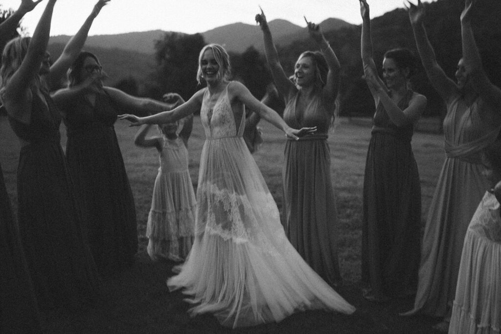 bride spinning and twirling around with her bridesmaids