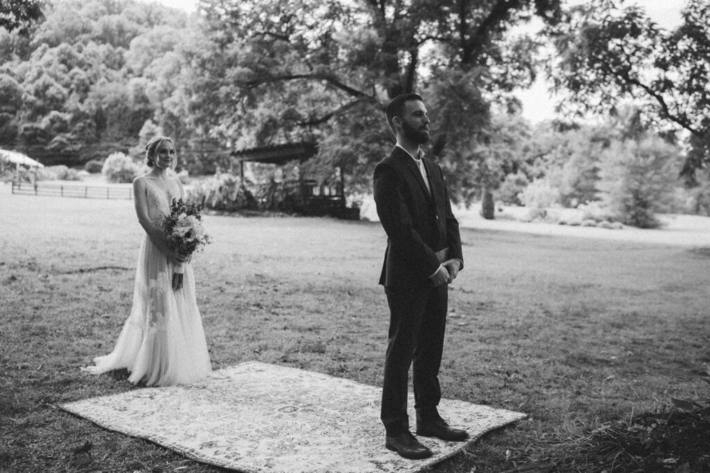 first look with bride and groom on vintage rug outdoors