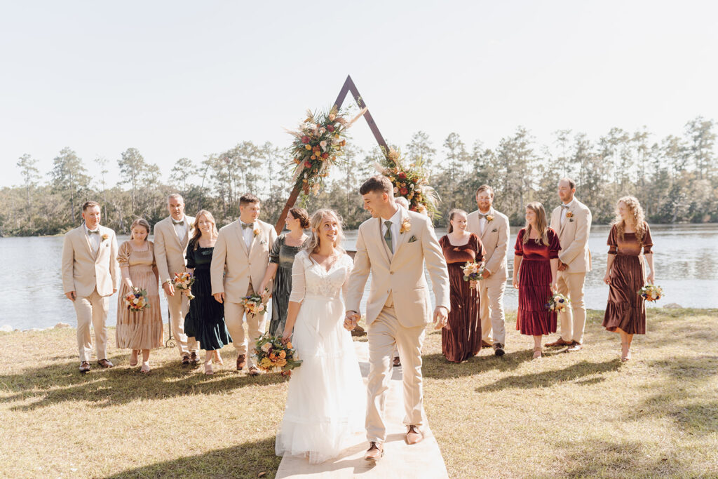 bride and groom walking with bridal party for knoxville tn wedding photos