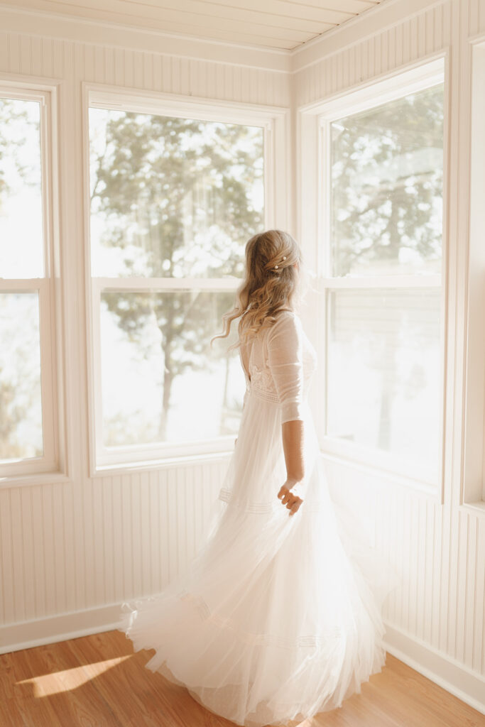 bride twirling in her dress getting ready wedding photos