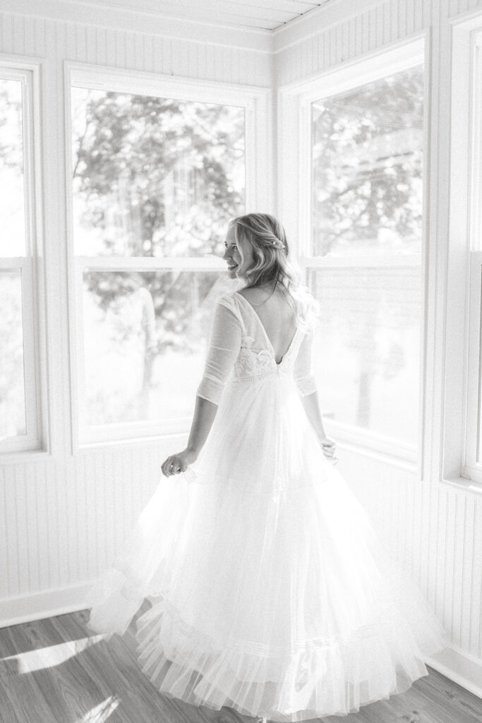 bride twirling in her dress getting ready wedding photos