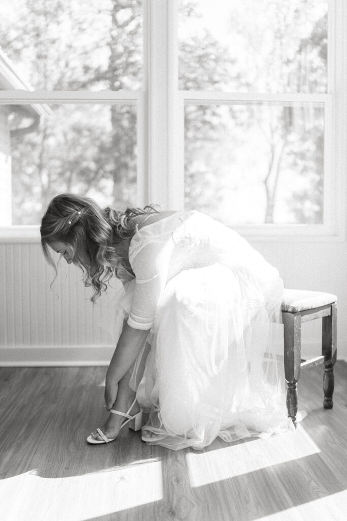 bride putting on wedding shoes