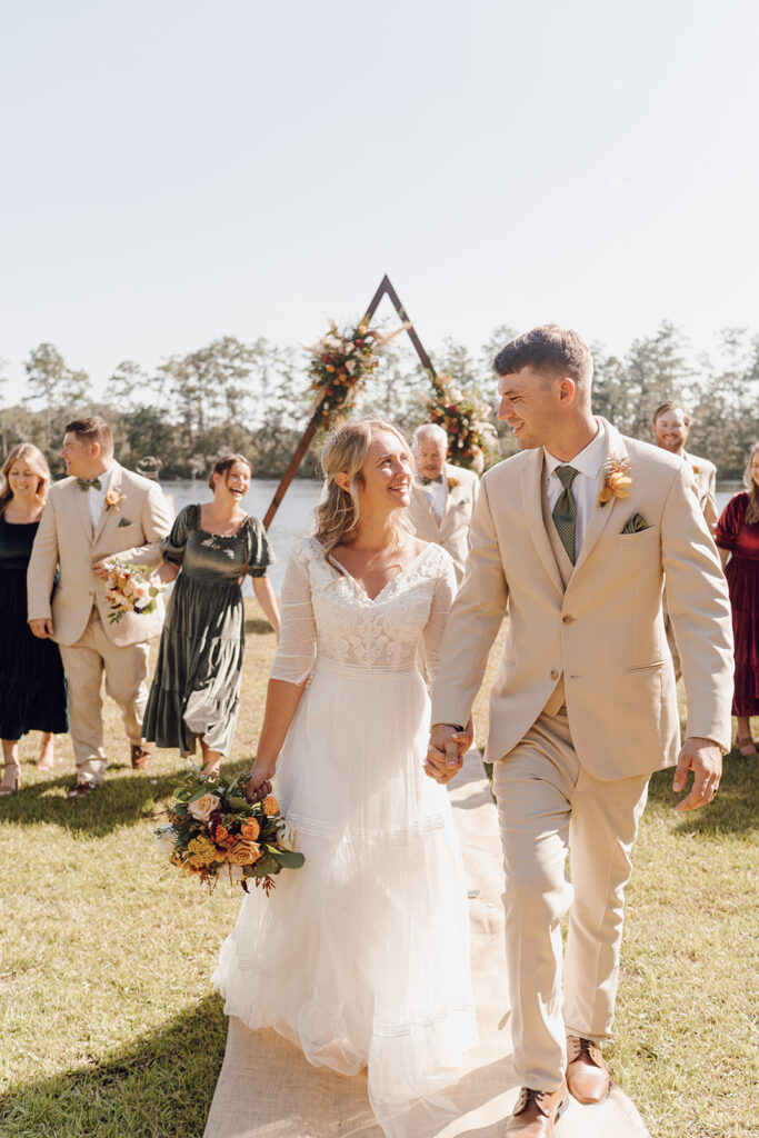 bride and groom walking with bridal party for knoxville tn wedding photos