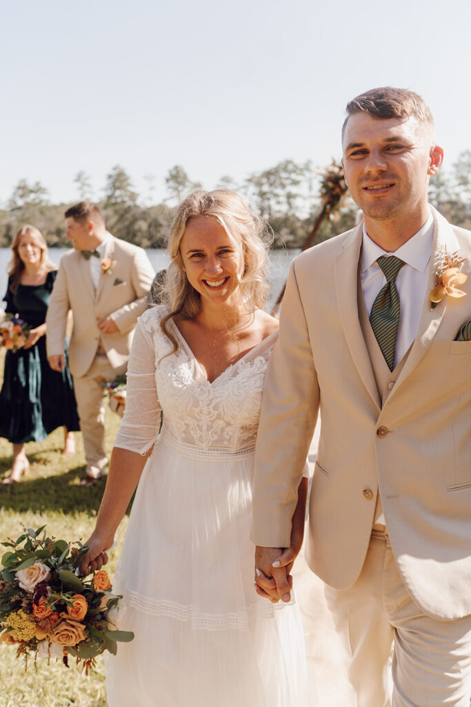 bride and groom walking with bridal party for knoxville tn wedding photos