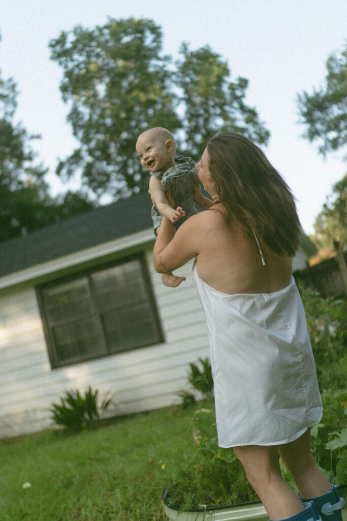mom and baby playing in the backyard