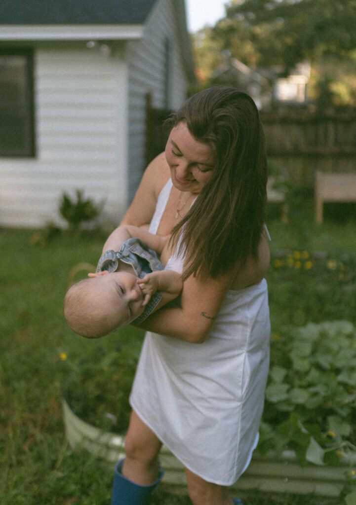 mom and baby playing in the backyard