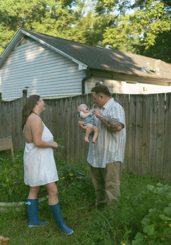 playful family photos in backyard with baby