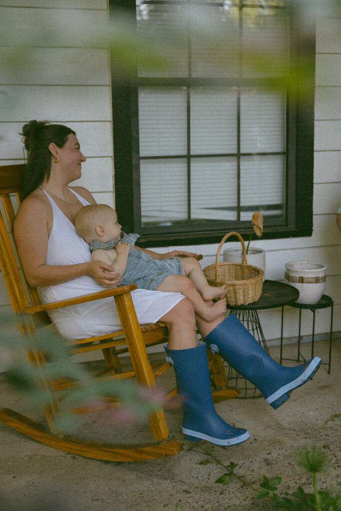 mom holding baby on the porch