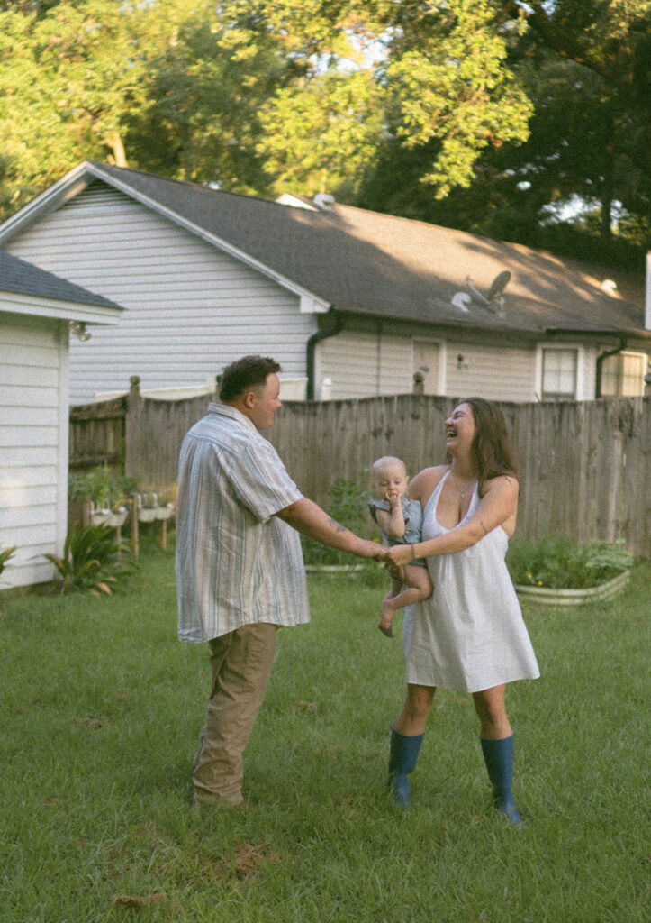couple holding hands and laughing in their backyard