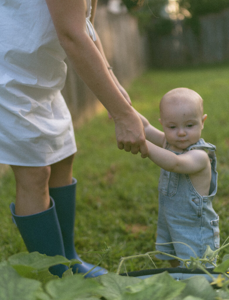 mom and baby playing in the backyard