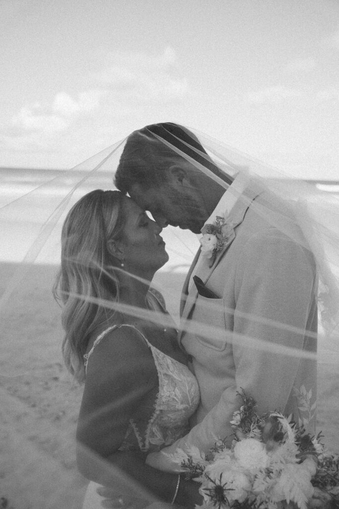 destination wedding photographer bride and groom under veil