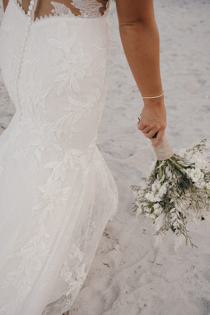 documentary style wedding photographer bride walking on the beach