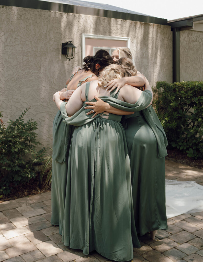 bridesmaids hugging first look photos