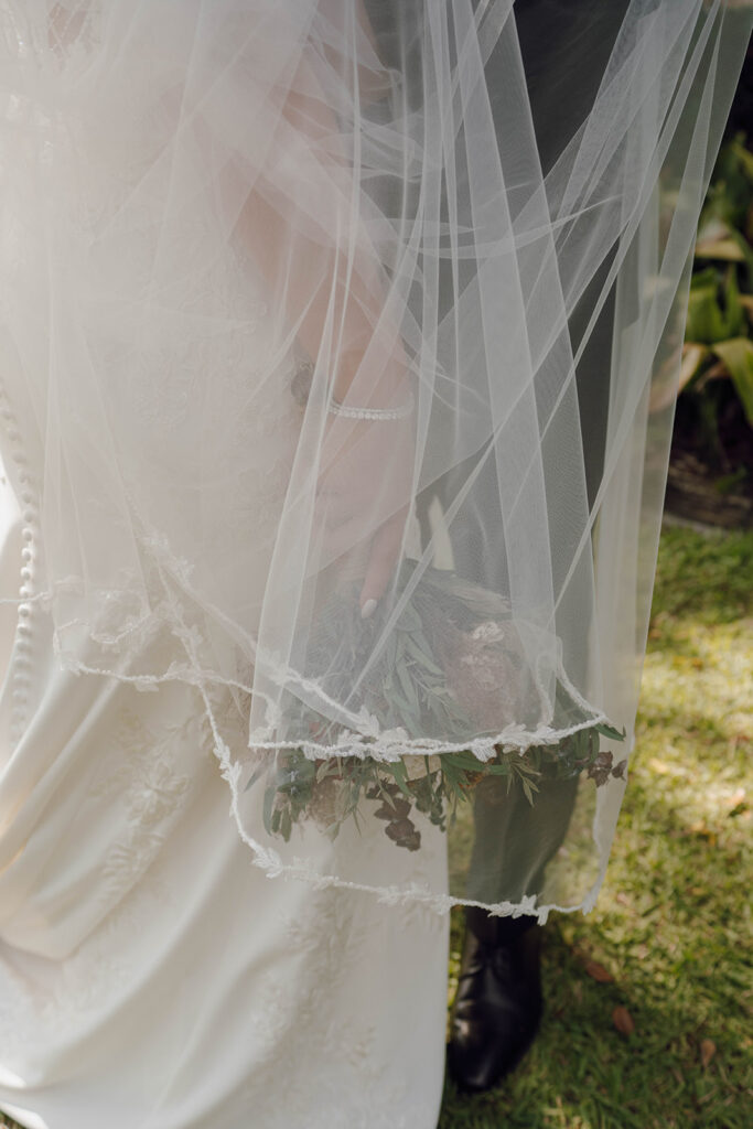 wedding veil photos with the bride and groom