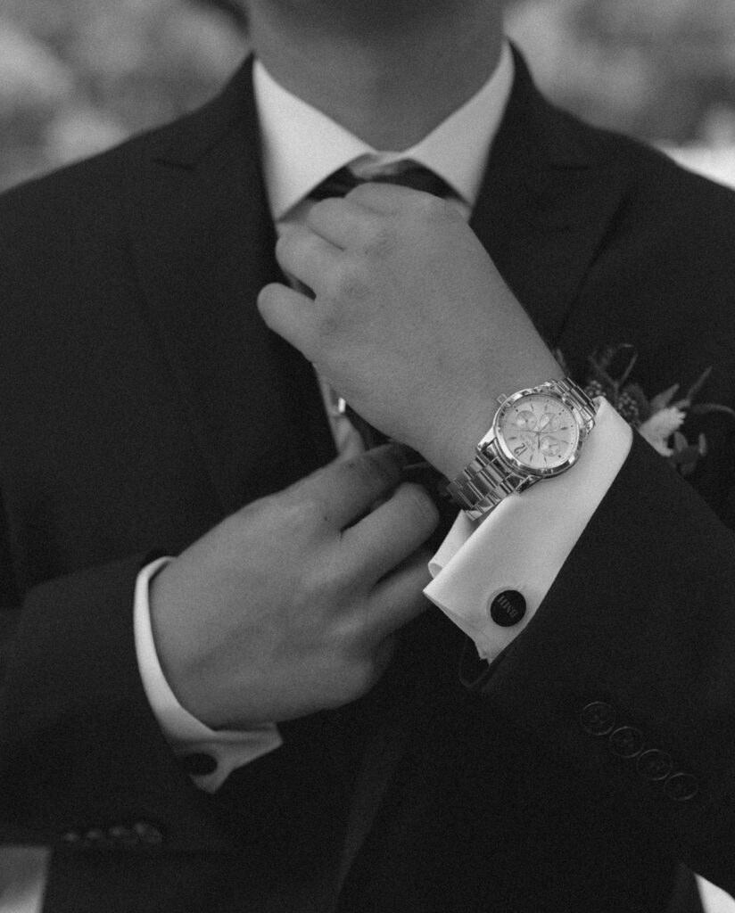 groom getting ready wedding photos adjusting tie