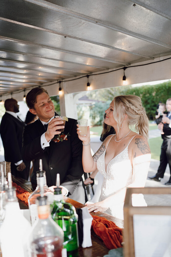 bride and groom cheersing at reception