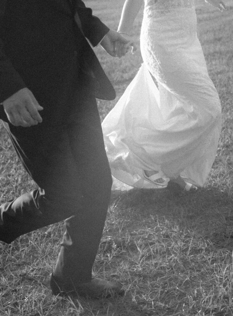 bride and groom running photos in black and white