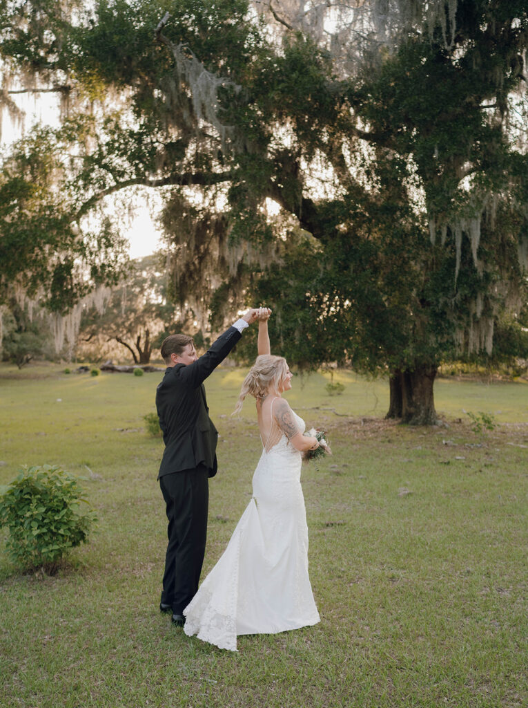 bride twirling with groom for portraits