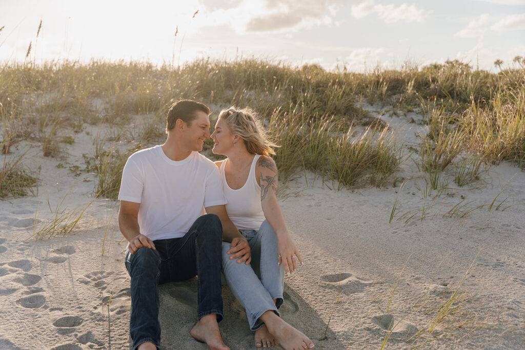couple posing on the beach for engagement photos