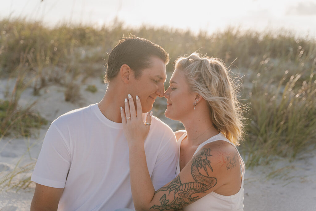 couple posing on the beach for engagement photos