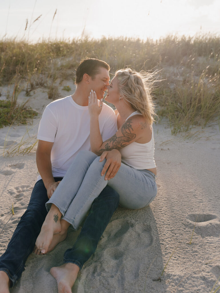 couple posing on the beach for engagement photos