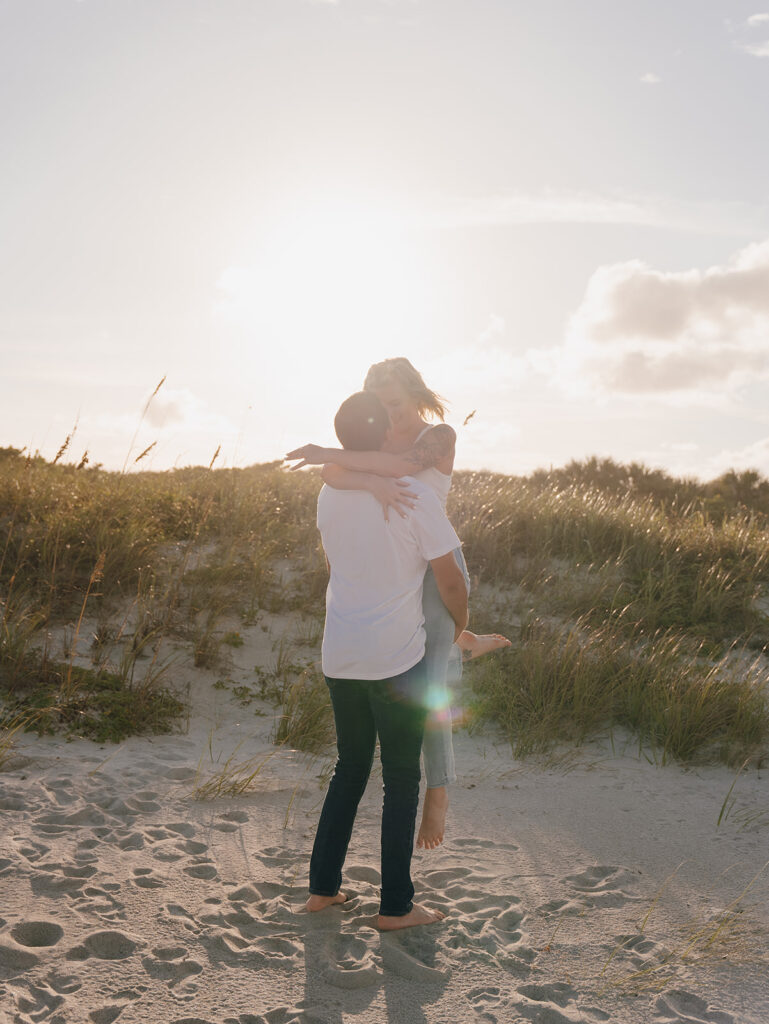 couple posing on the beach for engagement photos