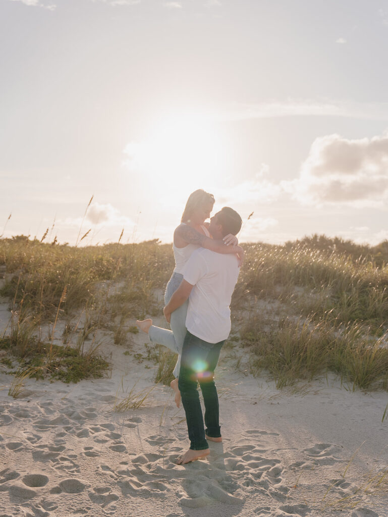 couple posing on the beach for engagement photos