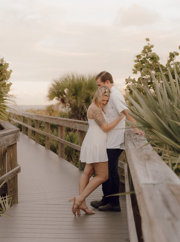 couple hugging on the beach walkway